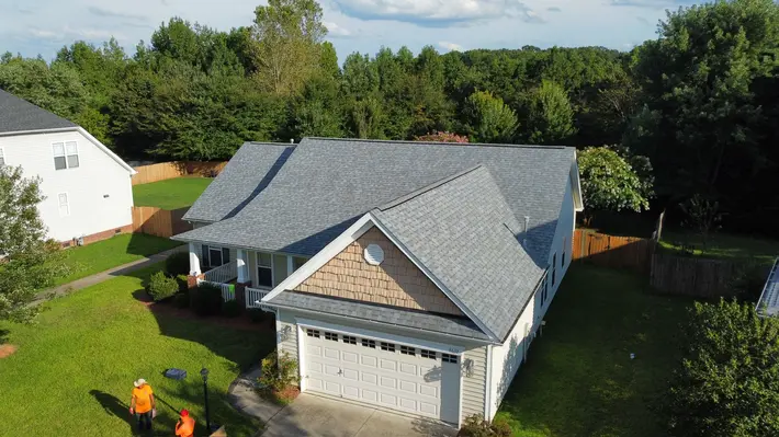 Homeowner reviewing roofing estimate with Triumph Roofing contractor in Charlotte