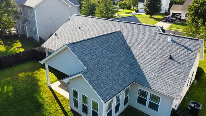 Satisfied customers in front of their newly repaired roof in Pineville NC