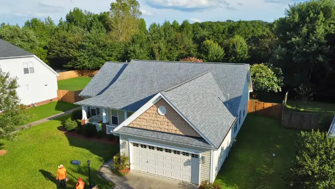 Satisfied homeowners standing in front of their new roof in Southpark, Charlotte NC