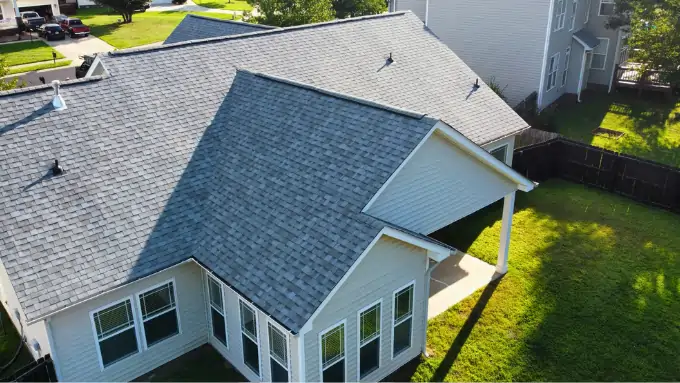 Happy homeowners standing in front of their new roof in Yorkmount, Charlotte NC