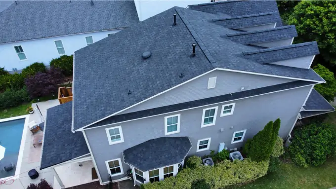 Satisfied homeowners standing in front of their newly replaced roof in Lake Wylie, SC