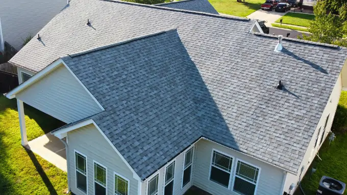 Satisfied family standing in front of their newly replaced roof in Palisades, Charlotte NC