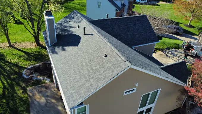 Homeowners smiling in front of their newly replaced roof in Myers Park, Charlotte NC
